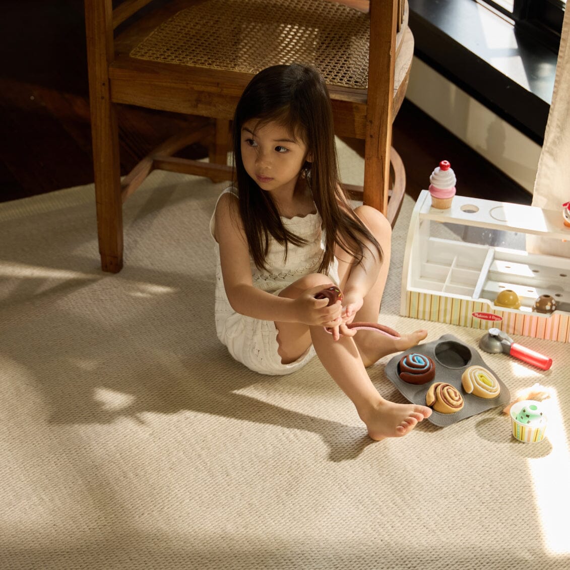 Young girl playing with toy baking set on a Dune Gray rug #dunegray
