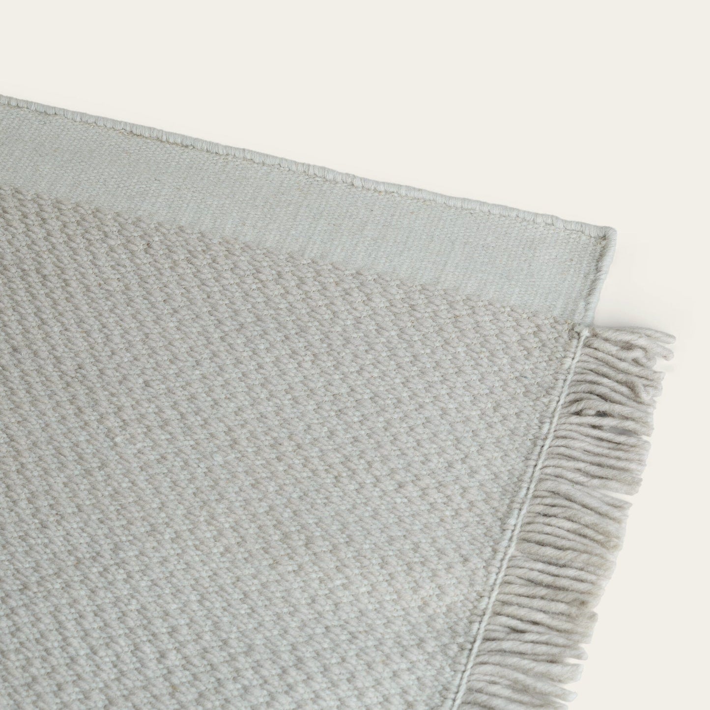 Gray textured blanket with frayed edge on a light gray background #foggray